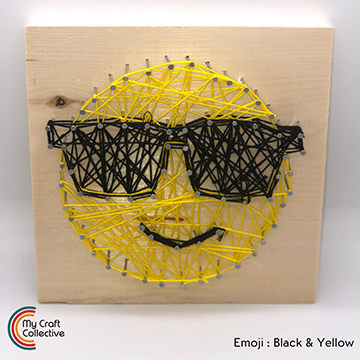 Sunglasses emoji string art kit made with yellow and black string.
