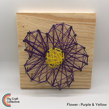 Flower string art made with yellow and purple string.