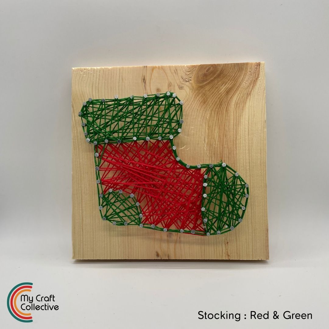 Stocking string art made with red and green string.