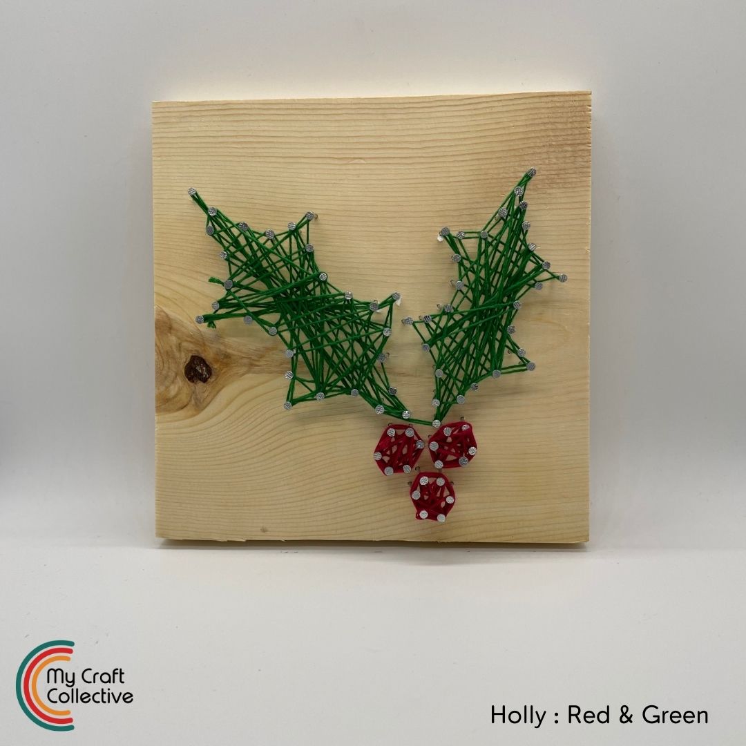 Holly berry string art made with red and green string.