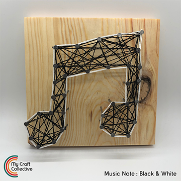 Music note string art made with white and black string.