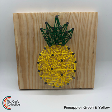 Pineapple string art made with yellow and green string.