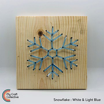 Snowflake string art made with light blue and white string.
